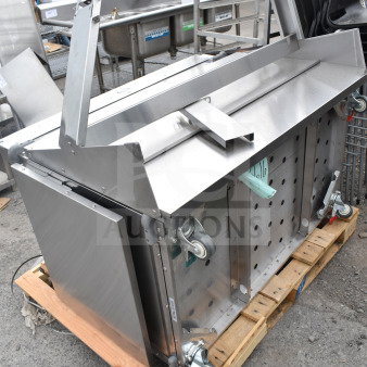Cadco 523616 Serving Station, stainless steel, on caster wheels, visible storage compartment, condition appears gently used.