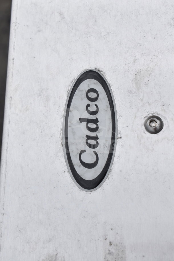 Cadco 523616 Serving Station with visible branding, metal surface, slight wear, accent screw detail.