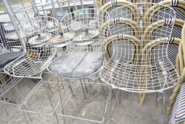 Set of 12 metal wire chairs, black seat pads, chrome finish legs. Mixed condition. Auction: 12 items per bid.