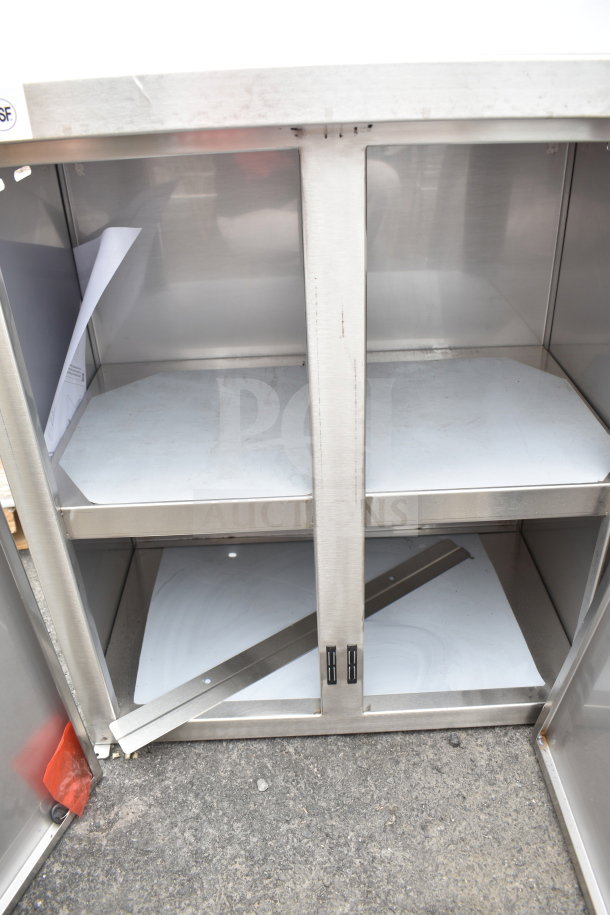 "New Regency 24-inch stainless steel wall cabinet, model CW-1524STHD-318, with hinged doors, scratch and dent condition."