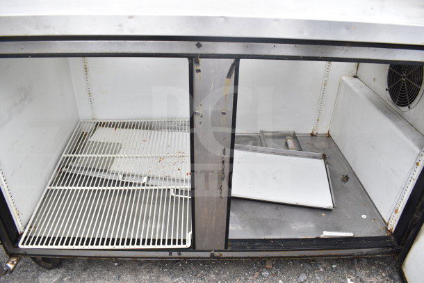 True TPP-67 commercial pizza prep table, no lids, stainless steel, visible wear, 115 volts, 1 phase.