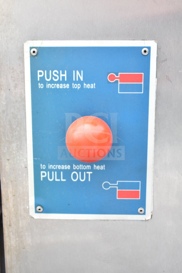 Control panel of a commercial gas-powered single deck pizza oven, featuring a red knob and instructions for heat adjustment.