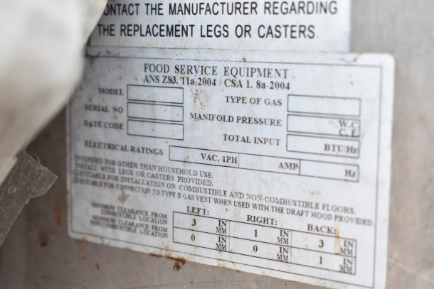 Label on commercial gas pizza oven detailing model, manifold pressure, and electrical ratings. Suitable for non-household use.