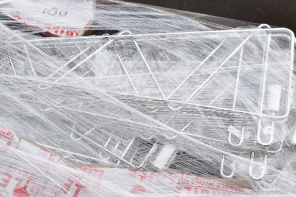 Pallet lot of chrome finish brackets, brand new with scratch and dent, wrapped in plastic, visible "Fragile" tape.
