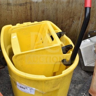 Yellow poly mop bucket with wringing attachment, features metal handle with red grip, on wheels; auction tag visible.