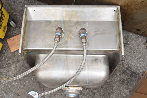 Commercial single bay wall mount sink with faucet and handles, stainless steel, visible wear, includes connecting hoses.