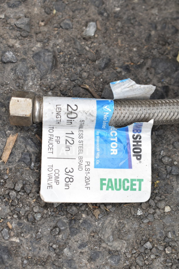 Tag on braided hose for sink installation. Reads: "20 in, 1/2 in FIP to 3/8 in Comp," "Stainless Steel Braid," "Plumbshop Faucet."
