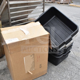 Lot with black poly bus bins stacked, cardboard box; outdoor setting, visible wear. Tags show "ALL ONE MONEY!" sale.