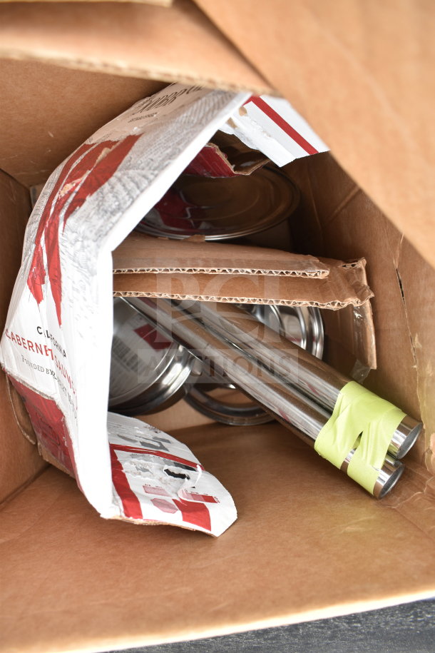 Cardboard box with miscellaneous items, including metal rods wrapped in tape, packaging material, and glass lids. Mixed condition.