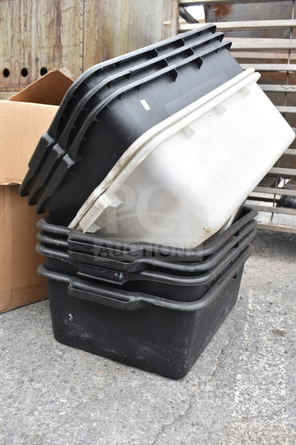 Lot of black poly bus bins, stacked, used condition, includes one white bin. Ideal for restaurant use or storage.