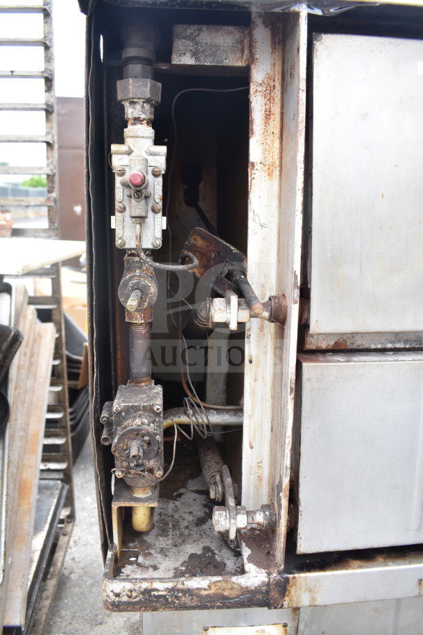 Bakers Pride commercial natural gas single deck pizza oven, interior view showing gas components, used condition.