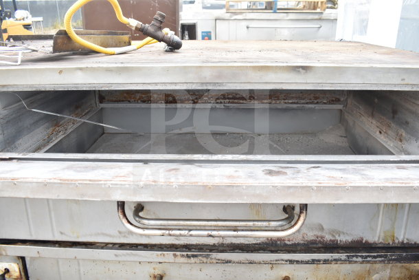 Bakers Pride commercial natural gas single deck pizza oven, stainless steel, used condition, visible wear and rust, gas hose attached.