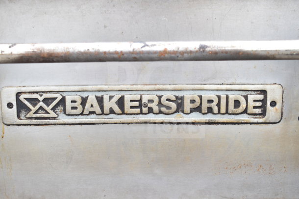Bakers Pride logo on a commercial natural gas-powered single deck pizza oven. Metal surface with some wear.