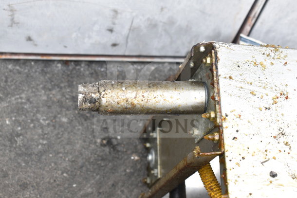 Commercial gas-powered floor deep fat fryer, showing signs of wear and grease buildup.