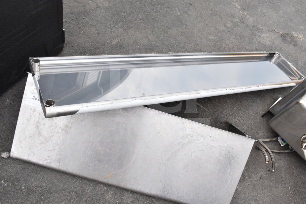 Two stainless steel shelves, slightly worn, with visible surface marks. Includes mounting holes, ideal for storage or display.