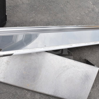 Two stainless steel shelves, slightly worn, with visible surface marks. Includes mounting holes, ideal for storage or display.