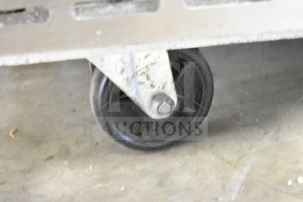 Close-up of a caster wheel from a 2023 Motak MPR-83-X commercial pizza prep table. Shows slight wear.