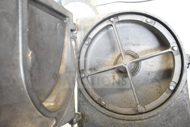 Commercial Pelican Head, no blade. Metal casing with visible interior mechanism. Slight wear, industrial-grade.