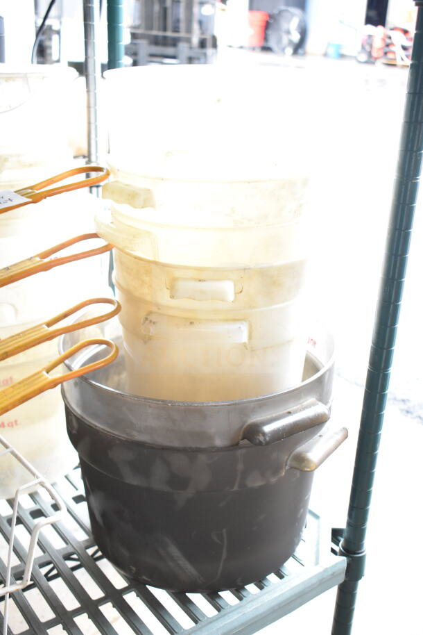 Lot of various kitchen items including plastic containers, metal fry baskets with handles, and large metal bowls.