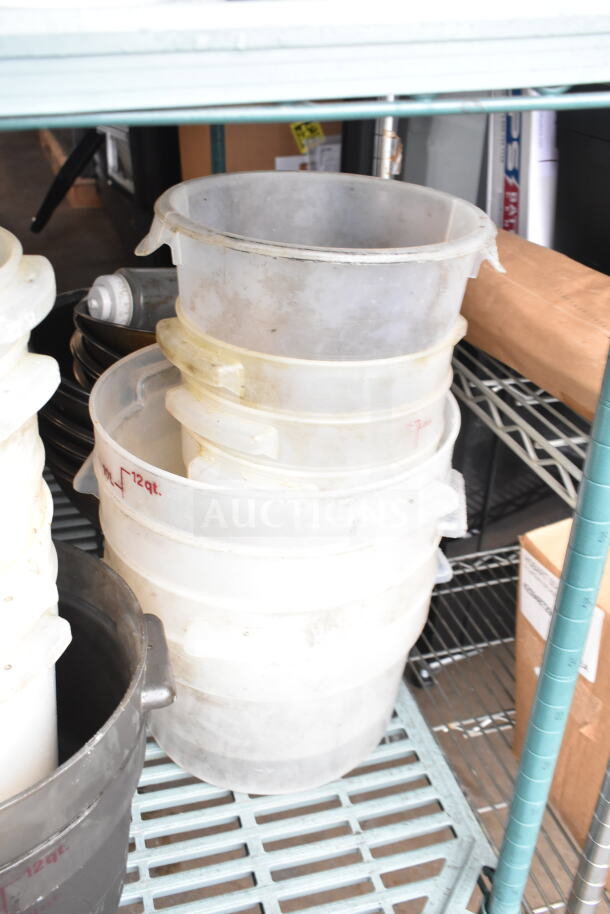 Lot including fry baskets and metal bowls, featuring stacked transparent 12 qt containers on a metal shelf, showing signs of use.