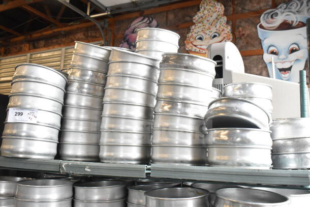 Lot of round metal baking pans stacked in two tiers, showing slight wear. Label indicates auction lot number 299.