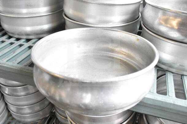 Lot of round metal baking pans, two tiers shown. Used condition with minor wear. Ideal for baking or catering needs.
