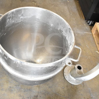 Stainless steel mixing bowl and dough hook attachment for Hobart mixer. Light wear visible, suitable for commercial use.