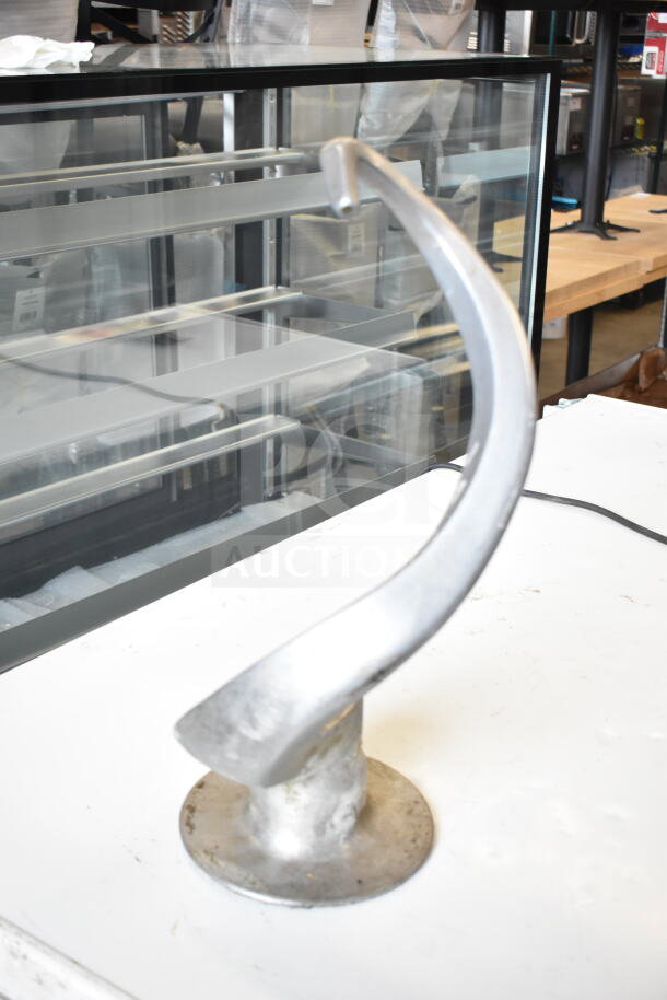 Stainless steel dough hook attachment for Hobart mixer, sturdy and used. Essential for bakery operations.