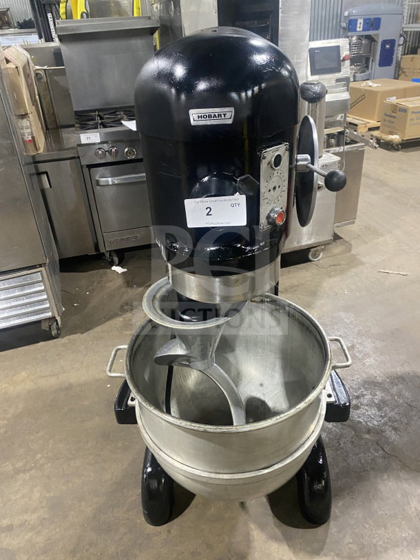 Hobart I800 commercial 80-quart mixer with stainless steel bowl, model 11-218590, 208V, 3-phase, visible dials and levers.