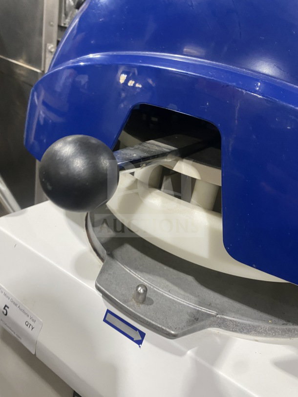 Doyon electric semi-automatic dough divider/rounder, white and blue, with handle and arrow marking, in good condition.