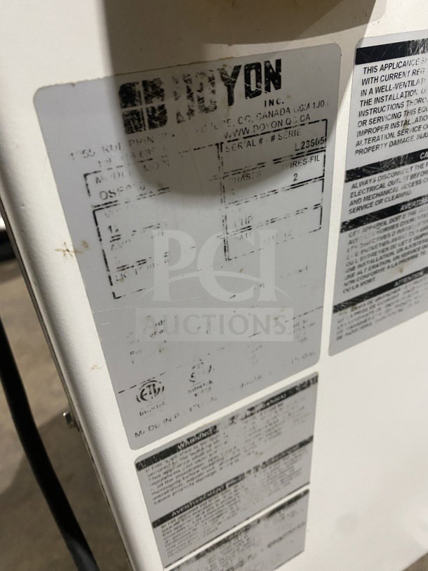 Doyon commercial dough divider/rounder, white and blue, electric semi-automatic, serial #L23651, fair condition.