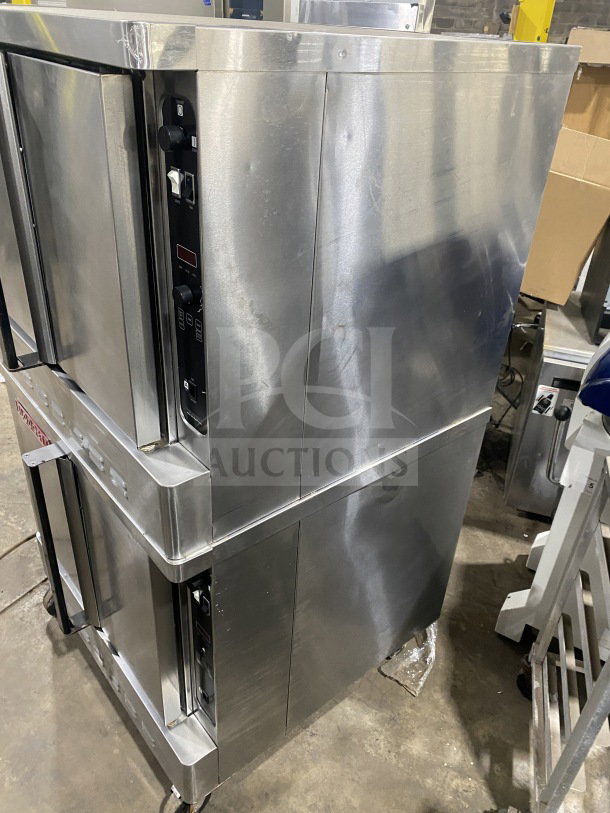 Blodgett double stacked stainless steel convection oven, gas-powered, Energy Star certified, with wired oven rack, on casters.