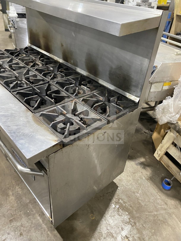 Bakers Pride stainless steel 10 burner gas range, model 955394604036, with double oven, backsplash, salamander shelf, on casters.
