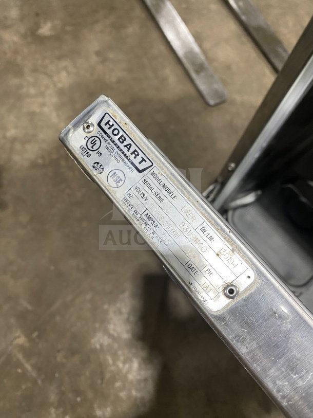 Hobart LXER Advansys commercial dishwasher label showing model, serial number, and voltage details on stainless steel.