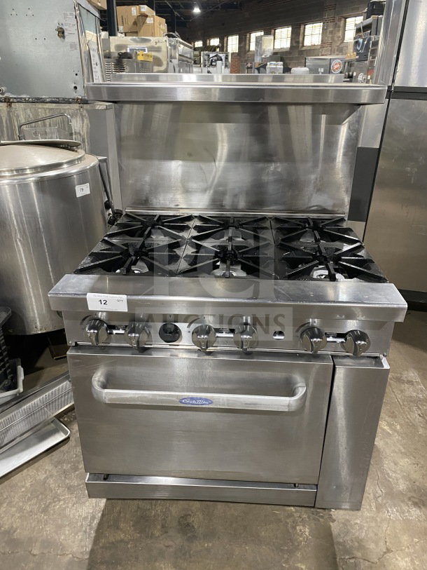 CookRite stainless steel 6-burner range/oven combo with backsplash, overhead salamander shelf, and wired oven rack, on casters.