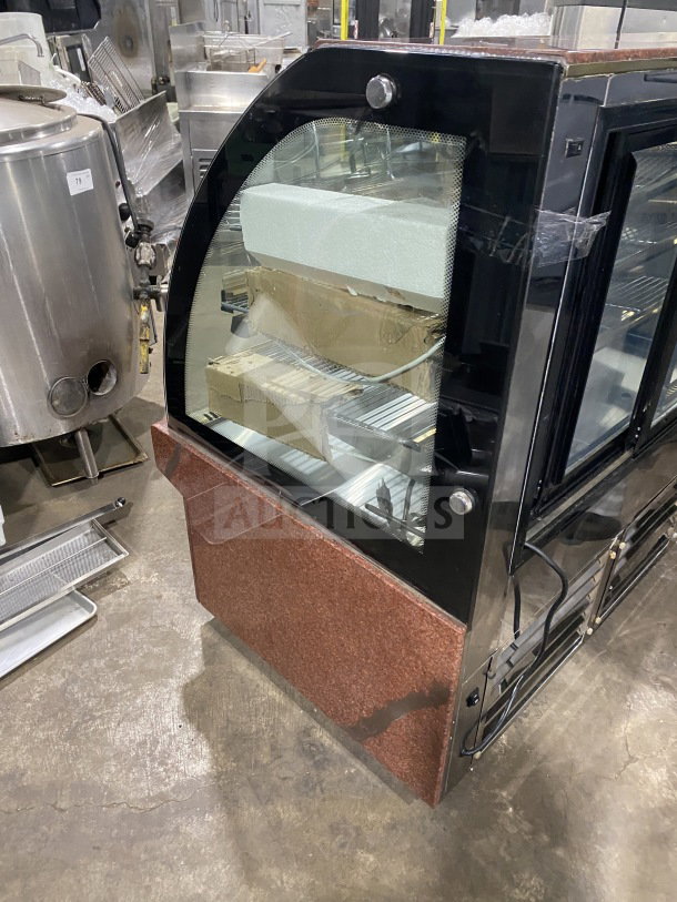 Leader EMCB48D 48" curved glass bakery display case. Non-refrigerated, clean condition, showcasing interior shelves.