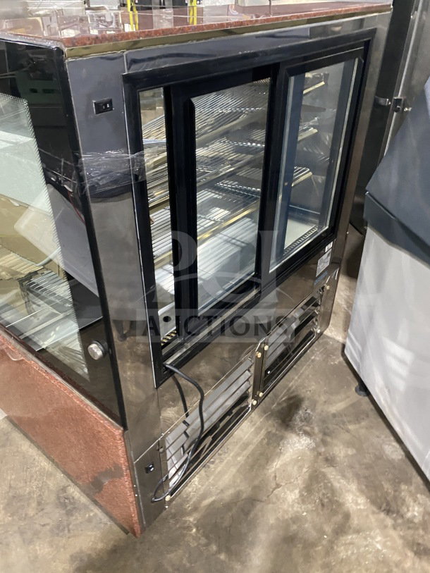 Leader EMCB48D 48" curved glass bakery display case, non-refrigerated, excellent condition, sturdy shelves, glass doors.