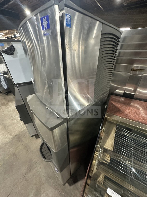 Manitowoc stainless steel ice machine, model SD0423W. Electric, water-cooled, with dispensing bin, 115V, on legs.