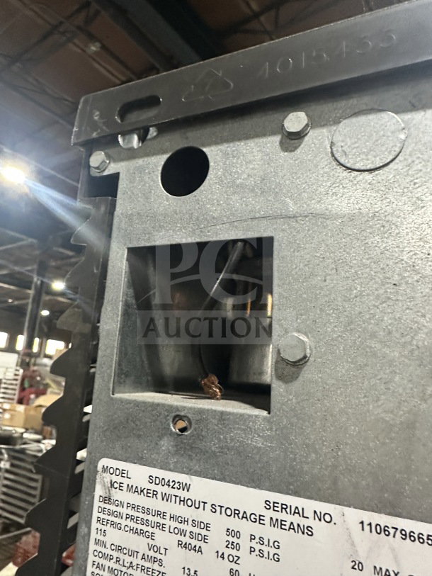 Manitowoc SD0423W ice machine close-up with visible serial number 110679665, showing stainless steel condition and specs label.