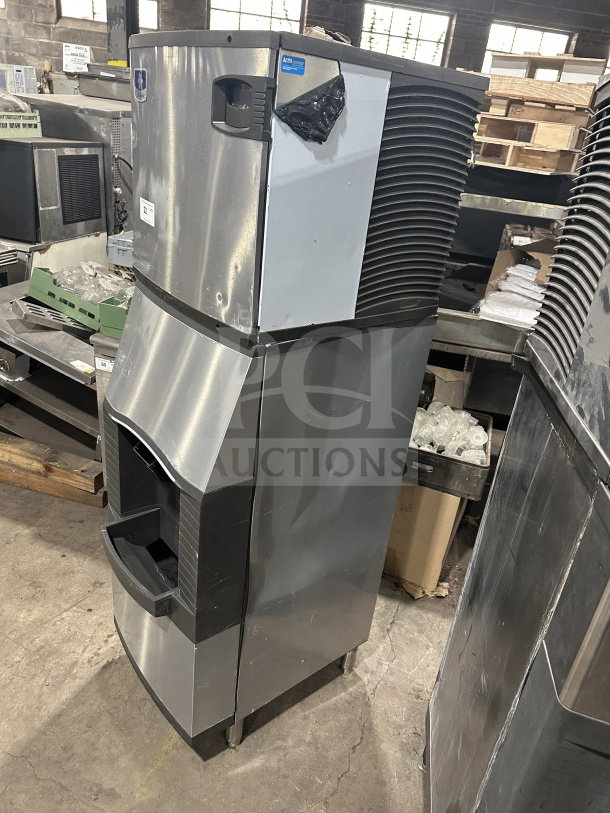 Manitowoc stainless steel ice making machine with ice bin, model ID0322A-161 and SPA310. On legs, 115V 1Phase.