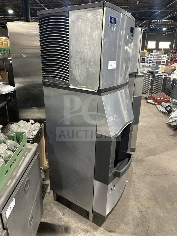 Manitowoc commercial stainless steel ice maker, model SPA310, includes ice bin and dispenser. Good condition, on legs.
