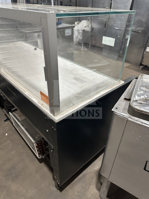 Commercial electric refrigerated display merchandiser, 220V, 1 Phase, open-air design, glass front, metal base, used condition.
