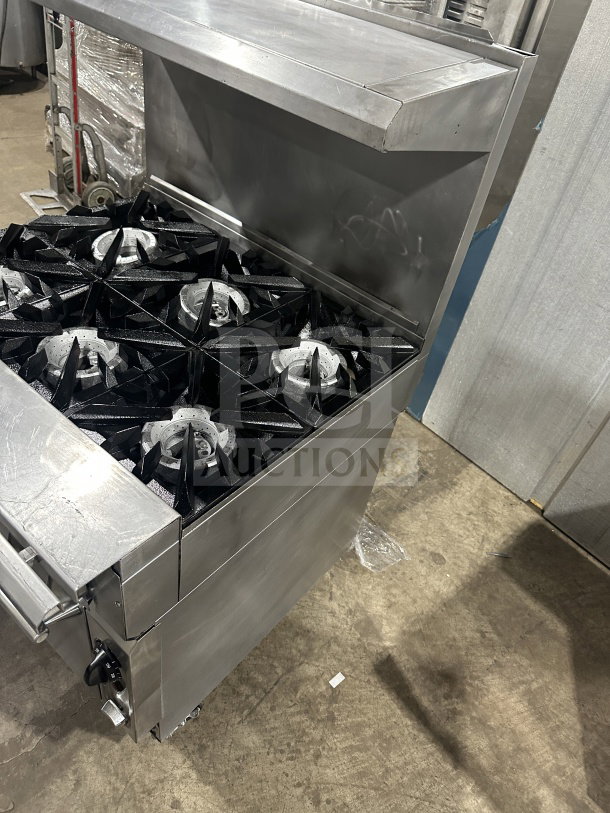 Vulcan commercial stainless steel 6-burner gas range/oven combo with backsplash and wired oven rack, on casters.