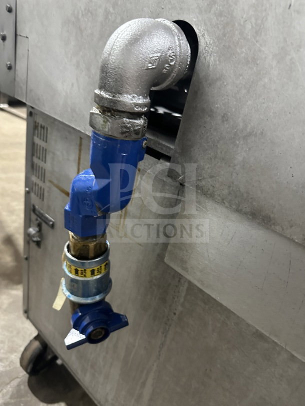 Gas connection detail of Vulcan stainless steel commercial 6-burner range/oven combo on casters.