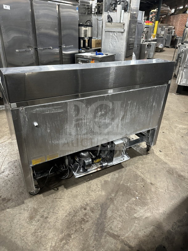 Asber PTS-60-16 60 stainless steel 2-door refrigerated prep table on casters, showing slight wear. Serial: 1309158M.