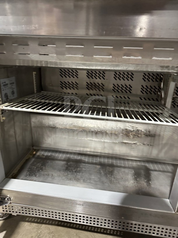 Asber PTS-60-16 60 refrigerated prep table, stainless steel, 2-door, on casters, visible wear inside, SN: 1309158M.