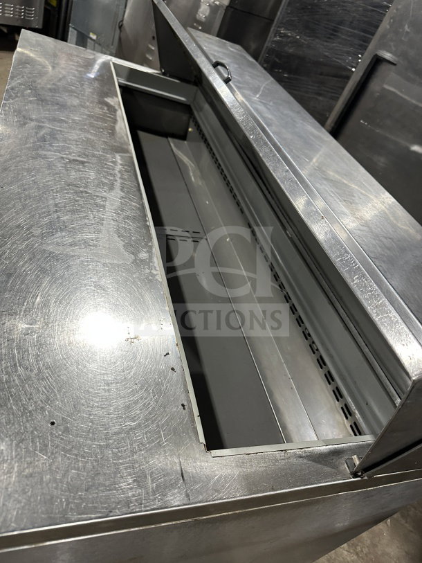 Asber PTS-60-16 60 refrigerated prep table, stainless steel, 2-door, on casters, visible storage area, good condition.