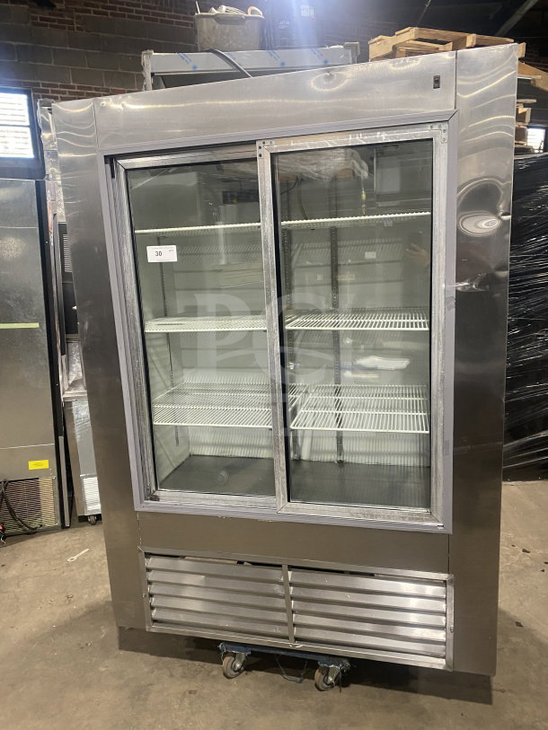 Leader LS54 commercial stainless steel reach-in refrigerator with sliding glass doors and poly coated wired racks. In good condition.