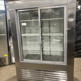 Leader LS54 commercial stainless steel reach-in refrigerator with sliding glass doors and poly coated wired racks. In good condition.