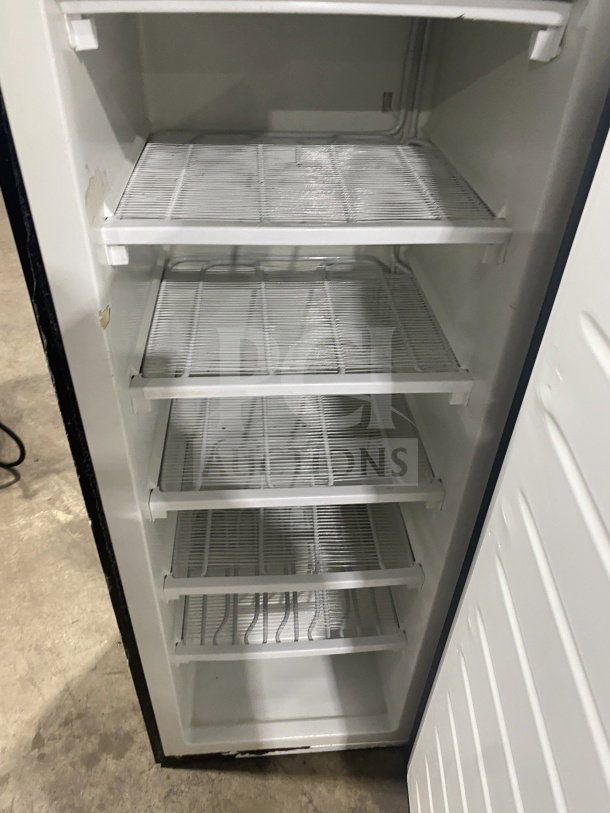 Frigidaire Model EFRF694 upright freezer with stainless steel finish, poly coated wired racks, single solid door, used condition.